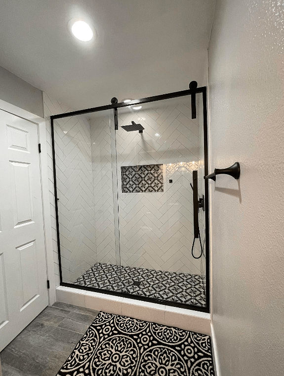 Eclipse Frameless Sliding Barn Door Shower Door in Black with Clear Glass